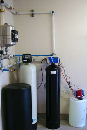Large, whole-house water softener with chlorine injection and carbon filter.